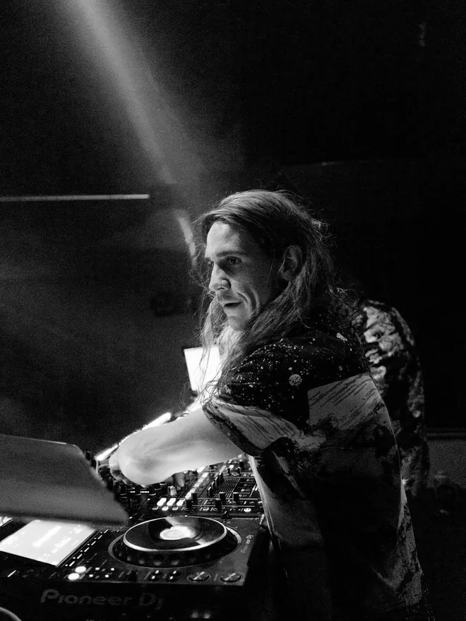 MLRTYME behind the decks — black-and-white live shot